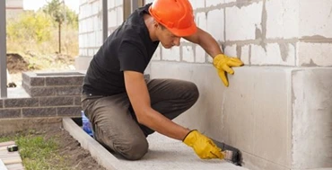 Waterproofing a foundation exterior wall with mortar